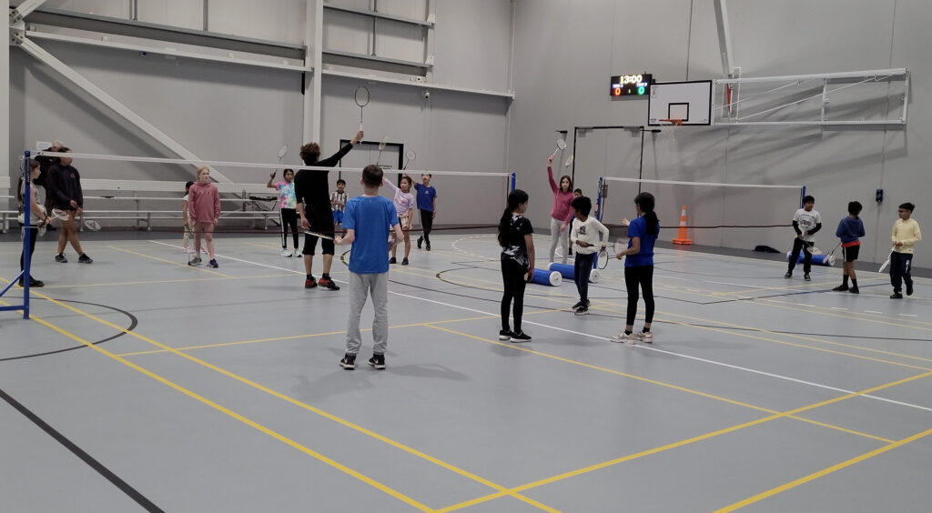 Badminton coach in Malta demonstrating forehand smash