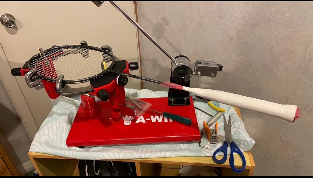 Professional badminton restringing service in Malta – Yonex strings being installed